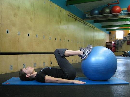 Personal Trainer, Tatum Rebel demonstrates hip press with ball
