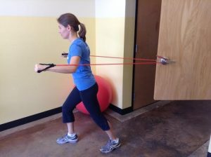 Personal Trainer, Tatum Rebel demonstrates chest press using a resistance band